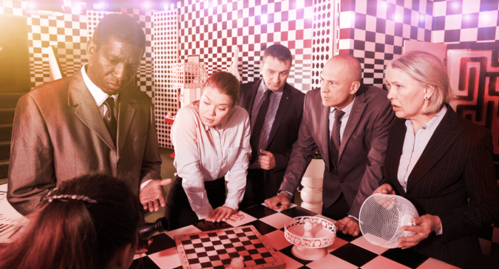 Group of people huddling round a table in a game room