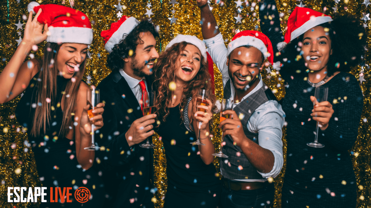 Corporate christmas party celebrating with free prosecco, gold confetti, wearing christmas hats